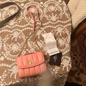pink leather small coach bag with handle that can be used as clutch